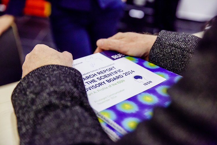 A pair of hands resting on a copy of the IGSN anual report