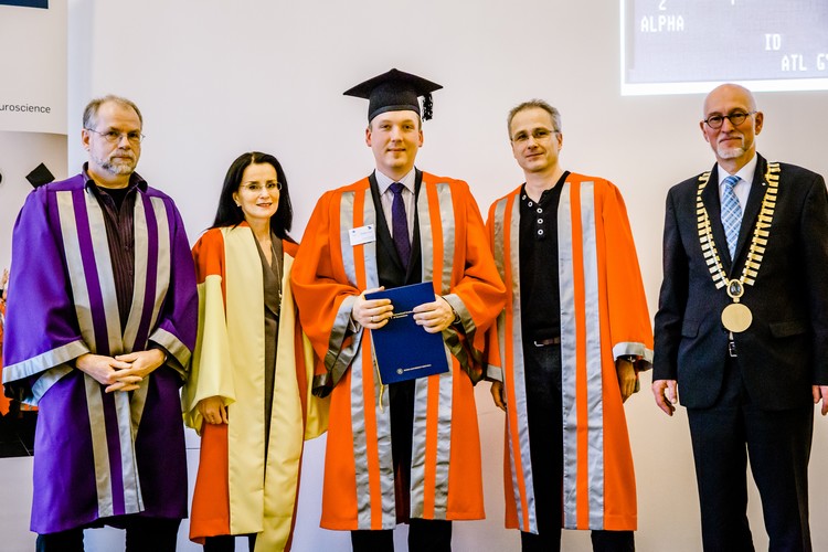 Professor Michael Hollmann, Professor Manahan-Vaughan, two male graduates in gowns and the rector. All are looking at the camera 