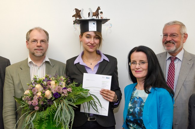 Michael Hollmann (still holding the flowers), Veronika (still holding her PhD certificate), Denise Manahan-Vaughan and Ulf Eysel all looking at the camera and smiling