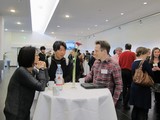 Andreas Marzoll standing at a table, in discussion with Takeo Watanabe and Yuka Sasaki