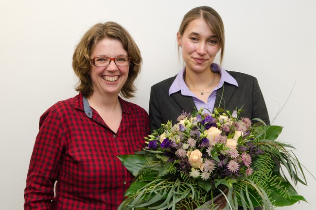 Ursula  Heiler and Veronika smiling for the camera. Veronika is holding a bunch of flowers