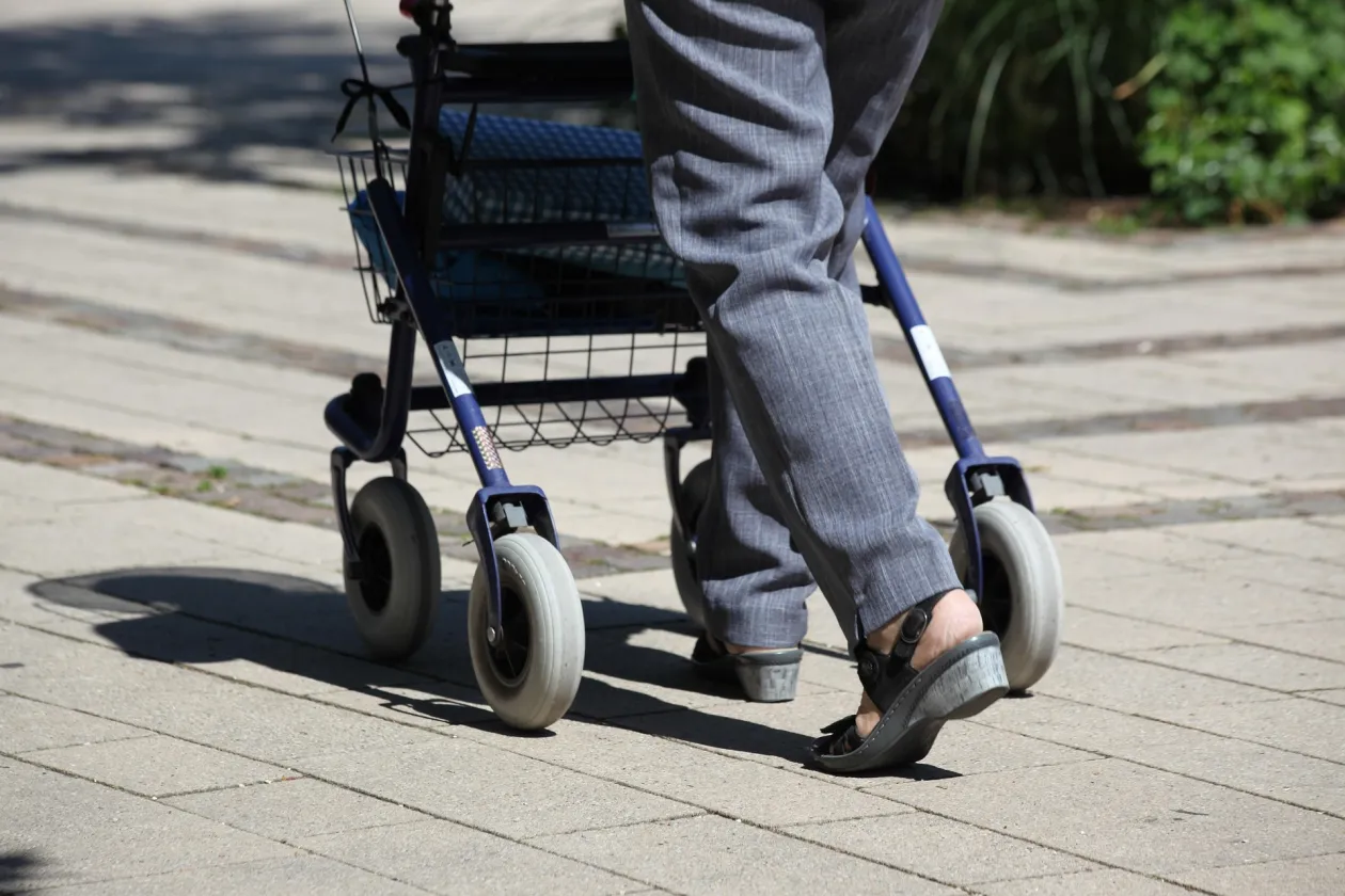 Eine Person schiebt einen Rollator