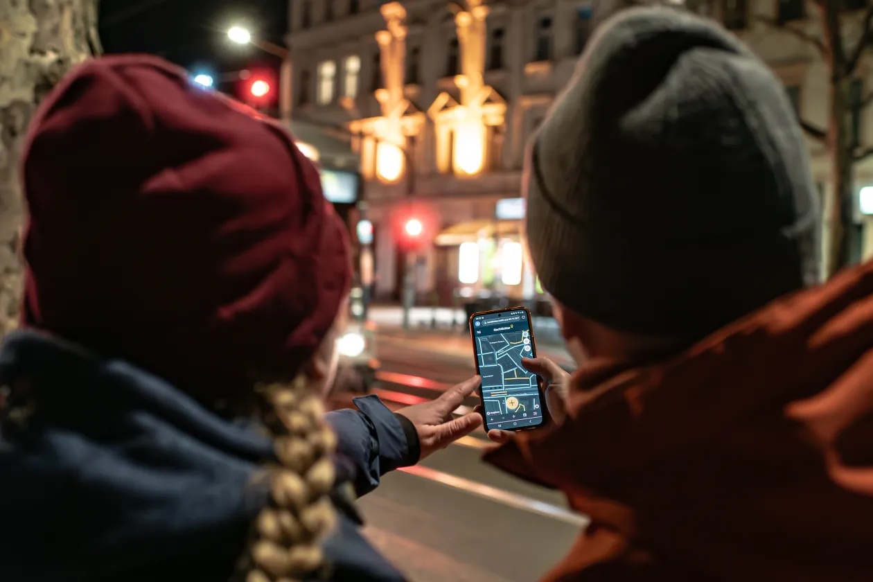 Zwei Menschen tragen eine Beleuchtungsquelle in eine App auf dem Handy ein