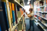 Frau am Bücherregal